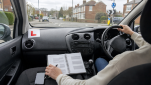 Learner driver planning a half-day intensive driving lesson inside a right-hand-drive car on a UK residential road.